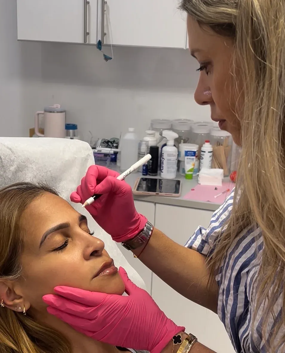 Dr. Elena Reitman performing an injectable treatment at GLOW